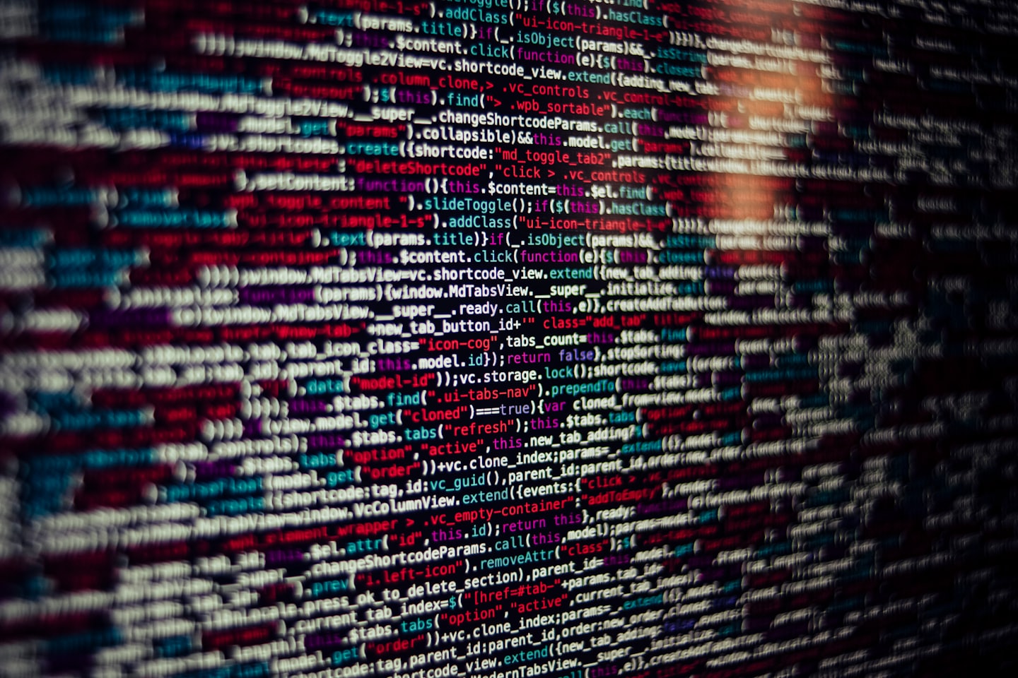 Lines of colorful computer code on a dark screen.