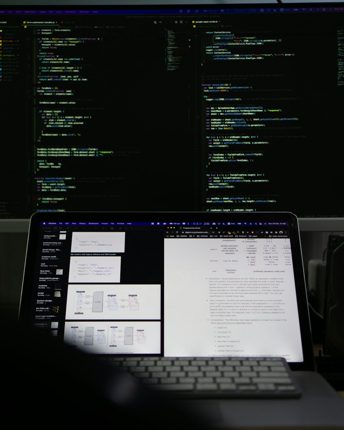 Two computer monitors display lines of code on a desk.
